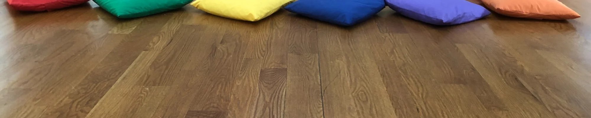 Colorful pillows on a clean hardwood floor